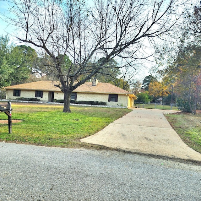 ranch-style house with a front lawn