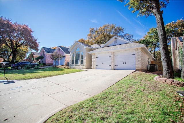 ranch-style home featuring a front yard, a garage, and central AC unit