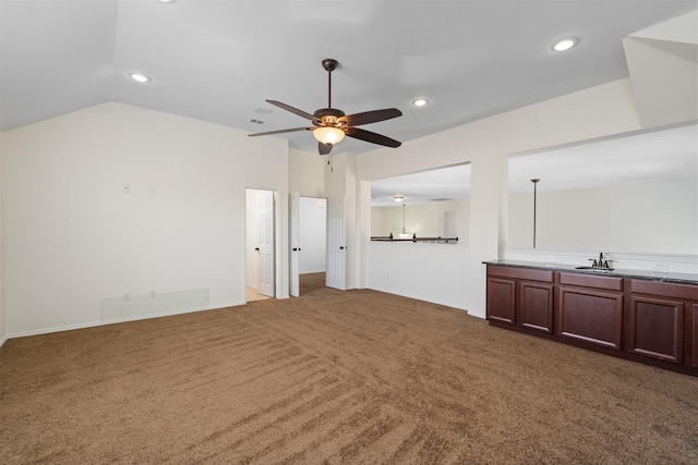unfurnished living room with vaulted ceiling, recessed lighting, carpet flooring, a ceiling fan, and a sink