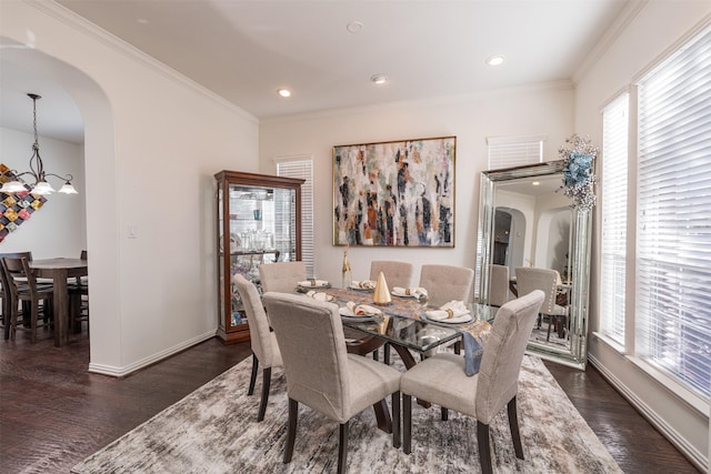 dining space featuring a chandelier, dark hardwood / wood-style flooring, and crown molding