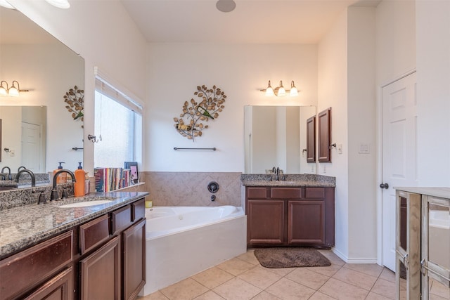 bathroom with a bathing tub, tile patterned flooring, and vanity