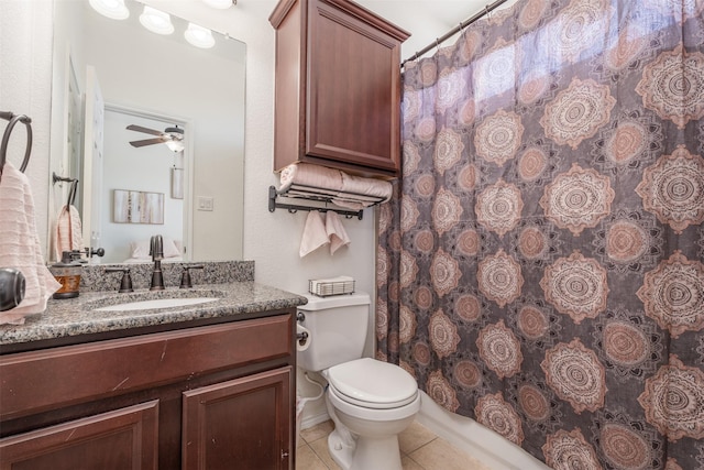 bathroom with vanity, ceiling fan, tile patterned flooring, toilet, and curtained shower