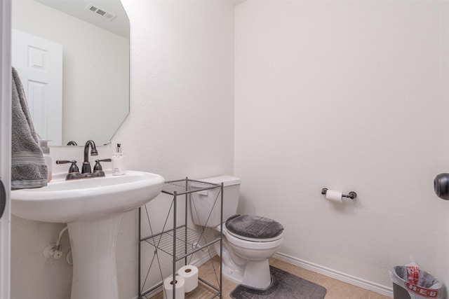 bathroom featuring tile patterned floors, sink, and toilet