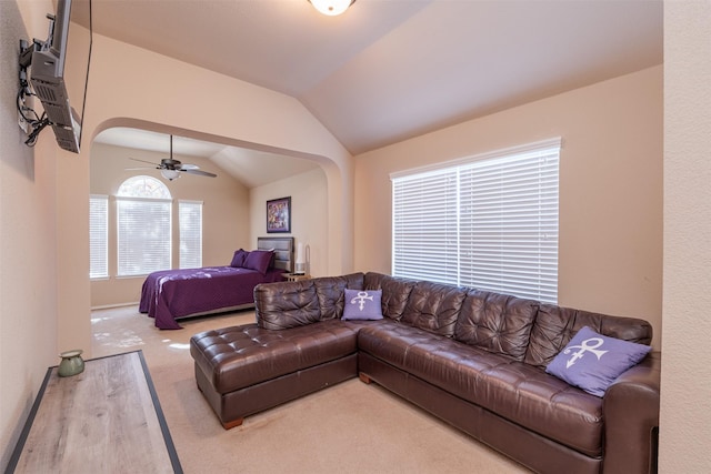 living room featuring hardwood / wood-style floors, ceiling fan, and lofted ceiling