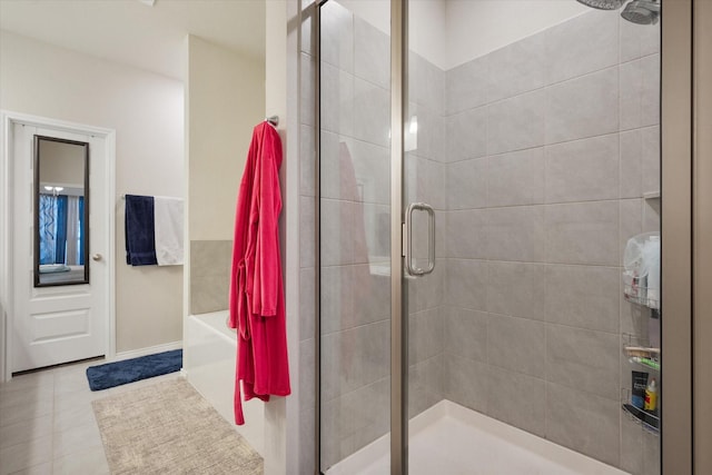 full bath with a shower stall and tile patterned floors