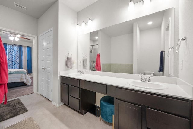 ensuite bathroom featuring double vanity, a stall shower, a sink, and visible vents