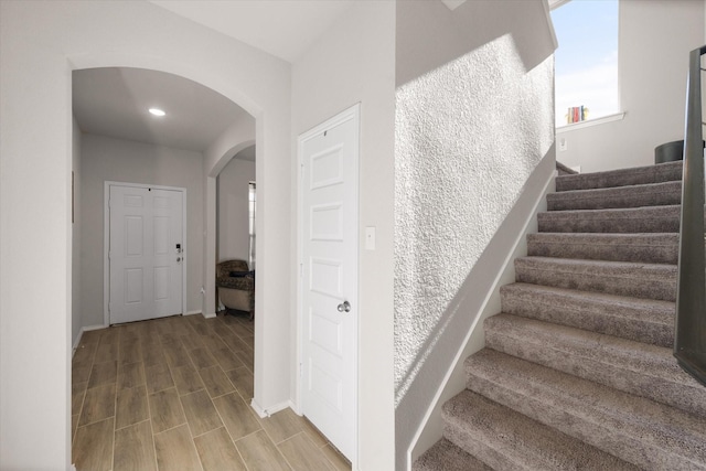 staircase with wood-type flooring