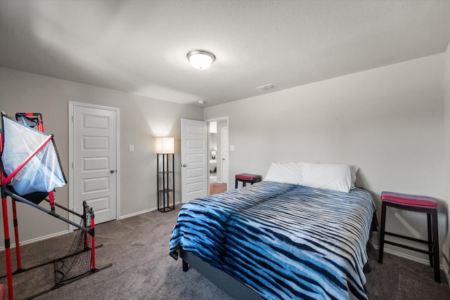 bedroom with carpet floors, visible vents, and baseboards