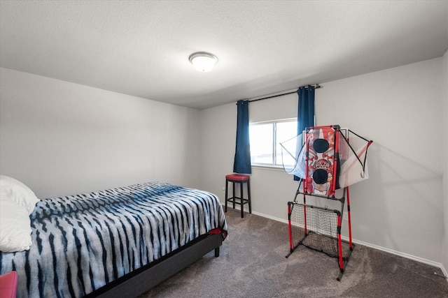 carpeted bedroom featuring a textured ceiling and baseboards