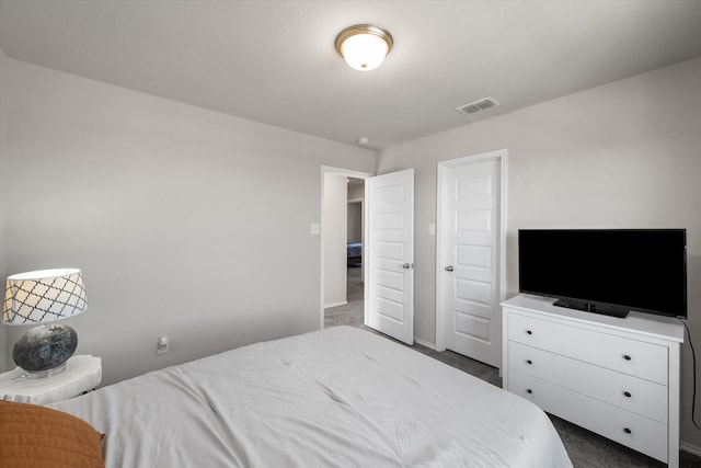 bedroom with carpet flooring, visible vents, and baseboards