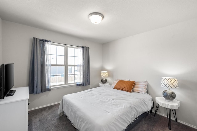 carpeted bedroom featuring baseboards