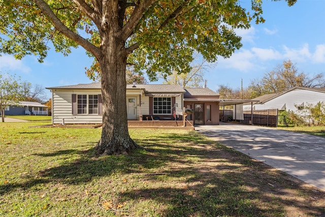 ranch-style house featuring a carport, covered porch, and a front yard