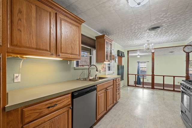 kitchen with crown molding, appliances with stainless steel finishes, sink, and a chandelier