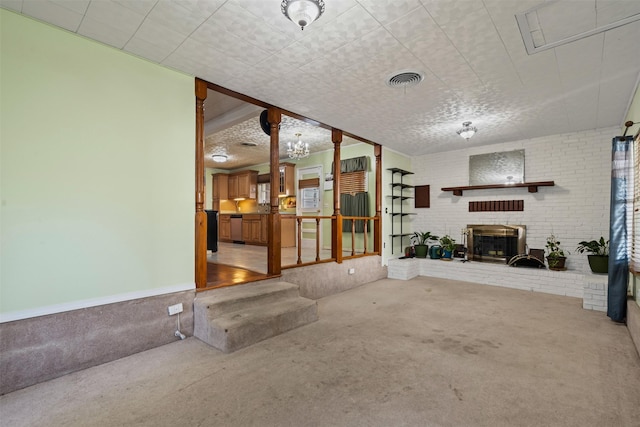 carpeted living room featuring brick wall