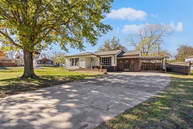 ranch-style home featuring a carport and a front lawn