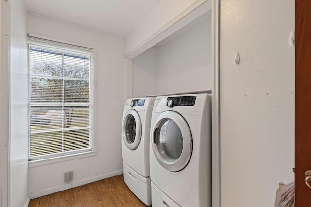 laundry room featuring light hardwood / wood-style floors and washer and dryer