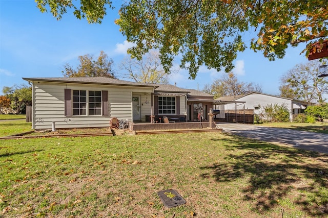 single story home with a front lawn and a carport