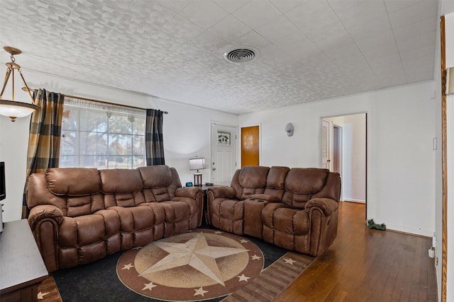 living room with dark hardwood / wood-style floors and a textured ceiling