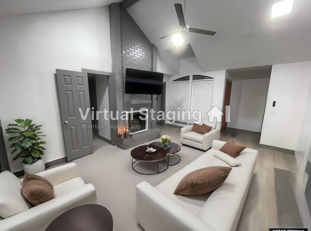 living room featuring wood-type flooring, a large fireplace, high vaulted ceiling, and ceiling fan