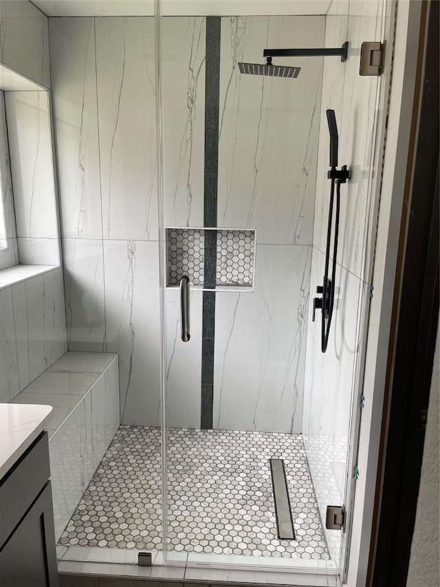 bathroom featuring vanity and a shower with shower door