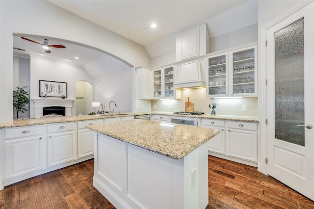 kitchen with white cabinetry, dark hardwood / wood-style flooring, vaulted ceiling, and sink