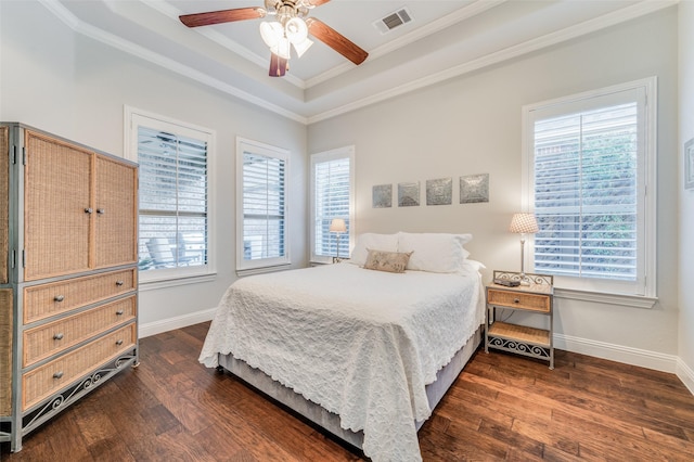 bedroom featuring ceiling fan, dark hardwood / wood-style floors, a raised ceiling, and crown molding