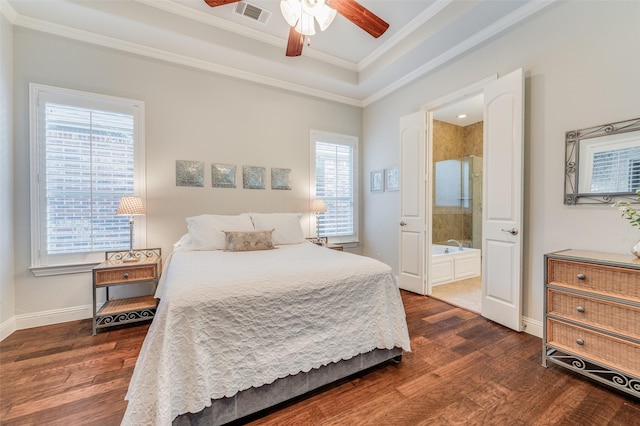 bedroom featuring dark hardwood / wood-style flooring, ensuite bathroom, ceiling fan, and crown molding