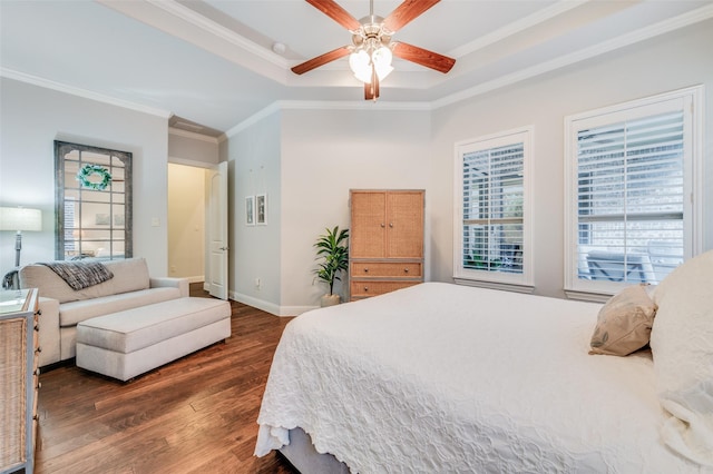 bedroom with a tray ceiling, ceiling fan, crown molding, and dark hardwood / wood-style floors