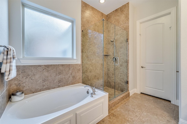 bathroom featuring independent shower and bath