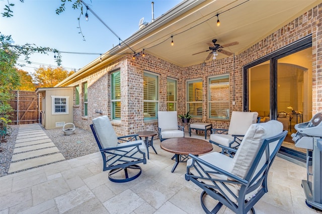 view of patio / terrace featuring ceiling fan and a shed