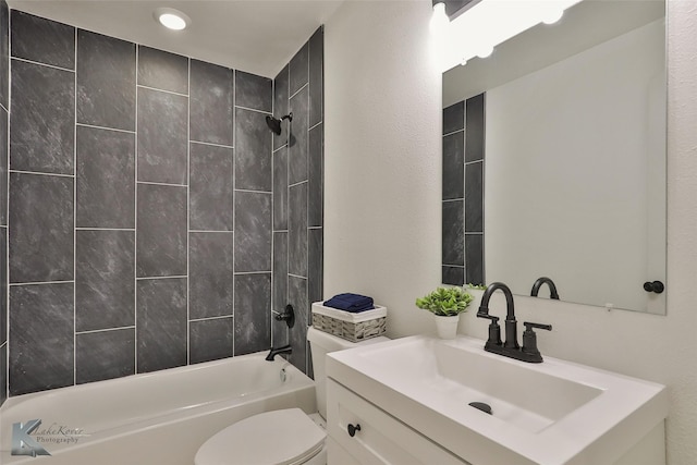 full bathroom with vanity, tiled shower / bath combo, and toilet