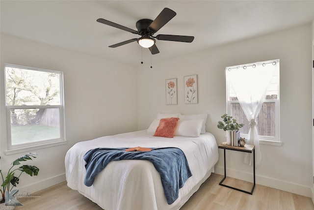 bedroom with light wood-type flooring and ceiling fan