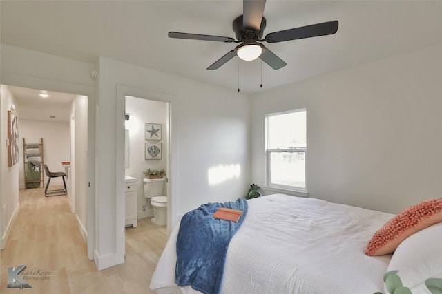 bedroom with ensuite bath, ceiling fan, and light hardwood / wood-style floors