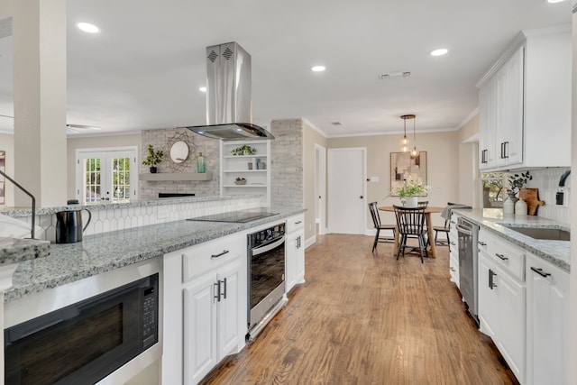 kitchen featuring white cabinetry, light stone countertops, black appliances, and island exhaust hood