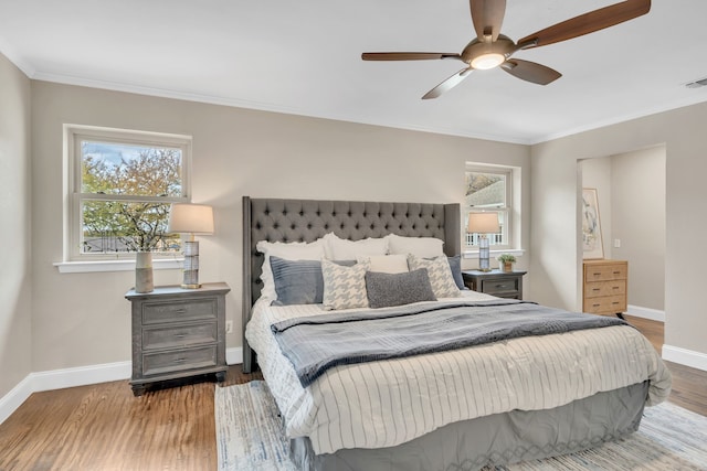 bedroom with hardwood / wood-style floors, ceiling fan, and crown molding