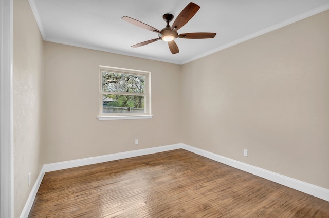 empty room featuring hardwood / wood-style floors, ornamental molding, and ceiling fan