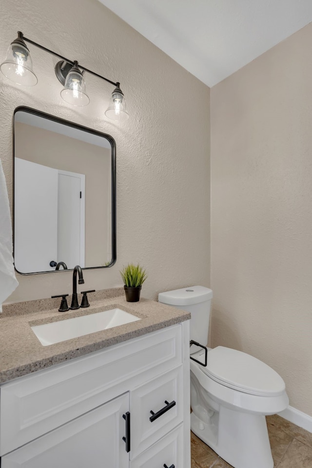 bathroom featuring tile patterned floors, vanity, and toilet