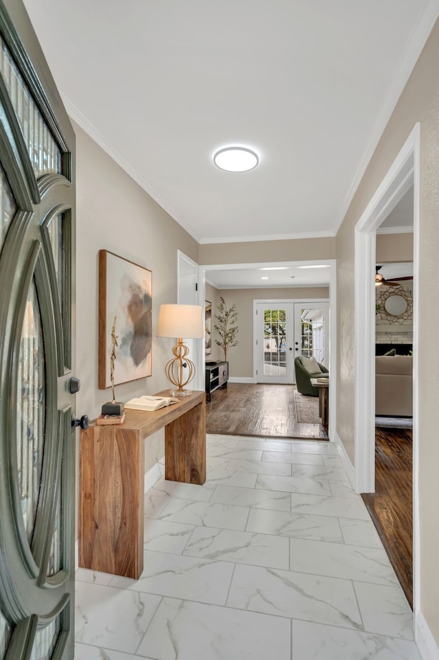 hallway with light wood-type flooring, ornamental molding, and french doors