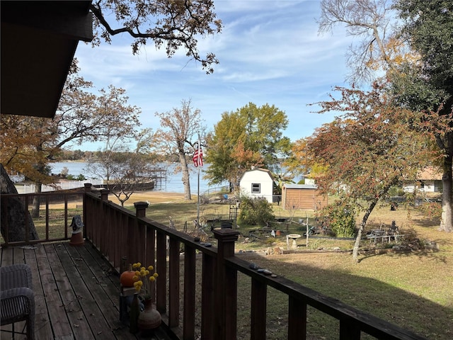 wooden deck with a yard and a water view