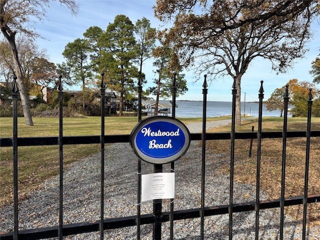 view of property's community featuring a water view and a yard