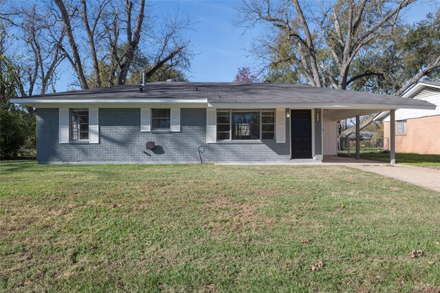 single story home with a front yard and a carport