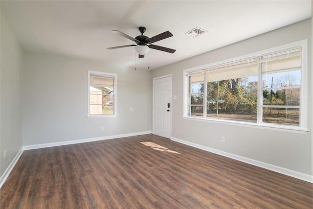 spare room featuring dark hardwood / wood-style floors and ceiling fan