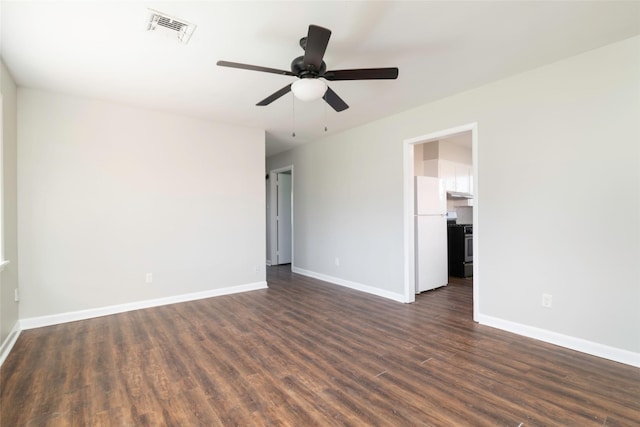 spare room featuring ceiling fan and dark wood-type flooring