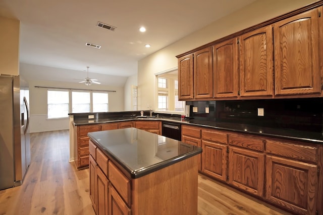 kitchen with stainless steel fridge with ice dispenser, kitchen peninsula, a center island, and black dishwasher