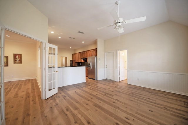 kitchen with stainless steel refrigerator with ice dispenser, french doors, vaulted ceiling, light wood-type flooring, and ceiling fan