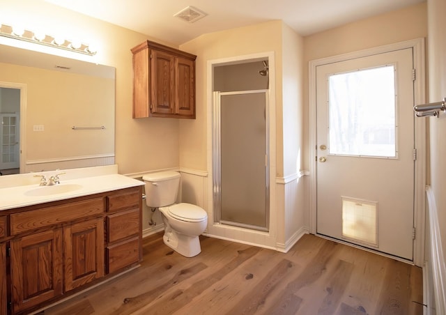 bathroom with vanity, hardwood / wood-style flooring, toilet, and a shower with shower door