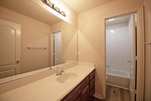 bathroom with vanity, toilet, and hardwood / wood-style floors