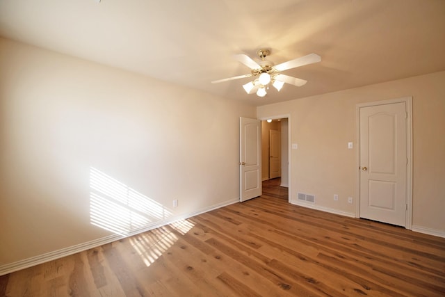 empty room with wood-type flooring and ceiling fan