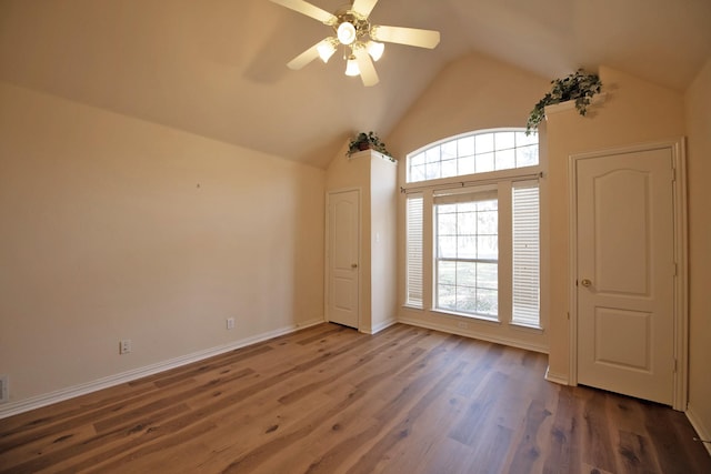 interior space with dark hardwood / wood-style floors, ceiling fan, and lofted ceiling