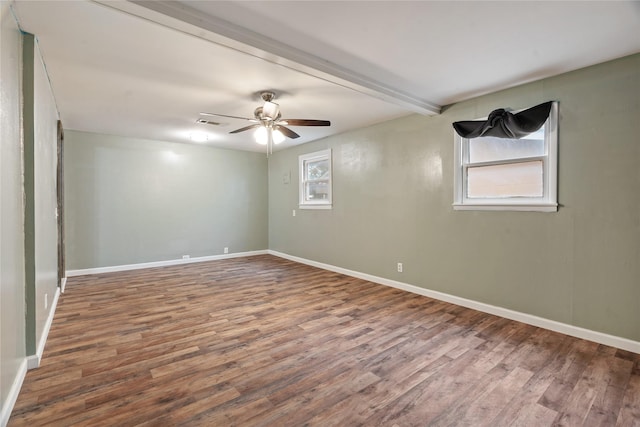 spare room featuring beamed ceiling, hardwood / wood-style floors, and ceiling fan